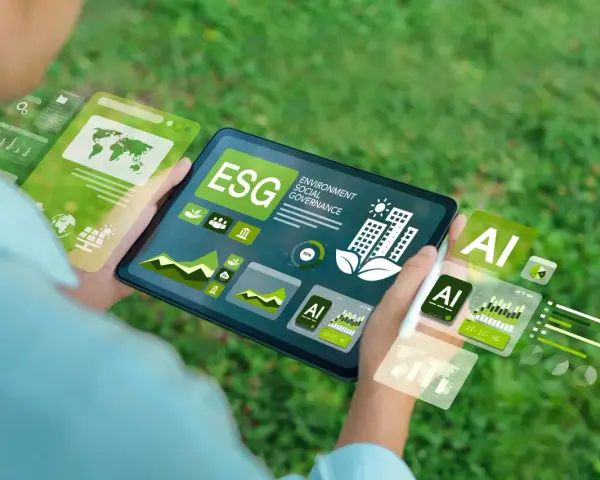 Schermo di un tablet con grafici ESG e AI, che illustra il significato di innovazione sostenibile e tecnologica.
