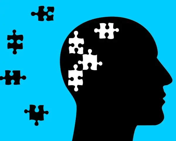 Silhouette di testa con pezzi di puzzle bianchi all'interno, che simboleggiano l'economia dell'attenzione.