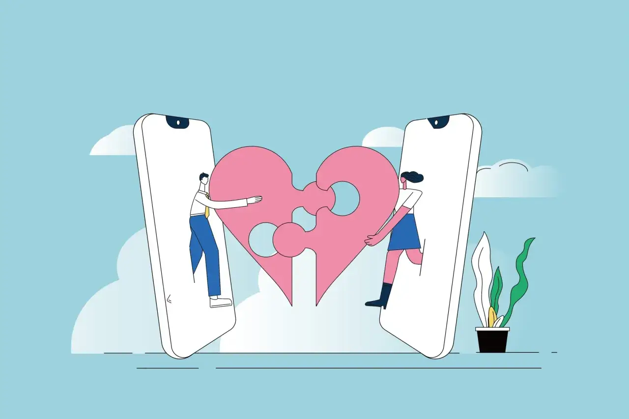 Uomo e donna da smartphone uniscono pezzi di cuore. Un'immagine che parla del significato di 