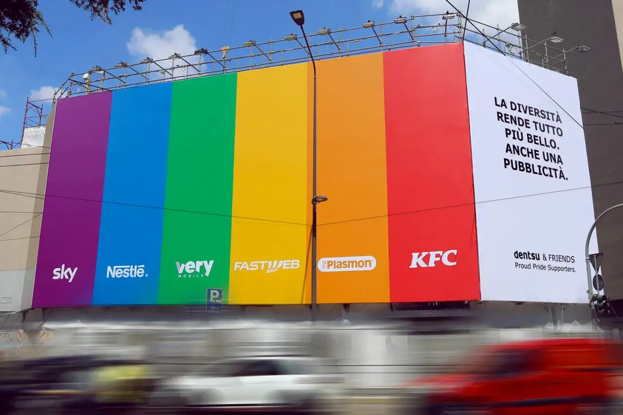 Pubblicit&agrave; arcobaleno con loghi aziendali. Un esempio di pink washing che celebra la diversit&agrave;, ma forse solo per marketing.